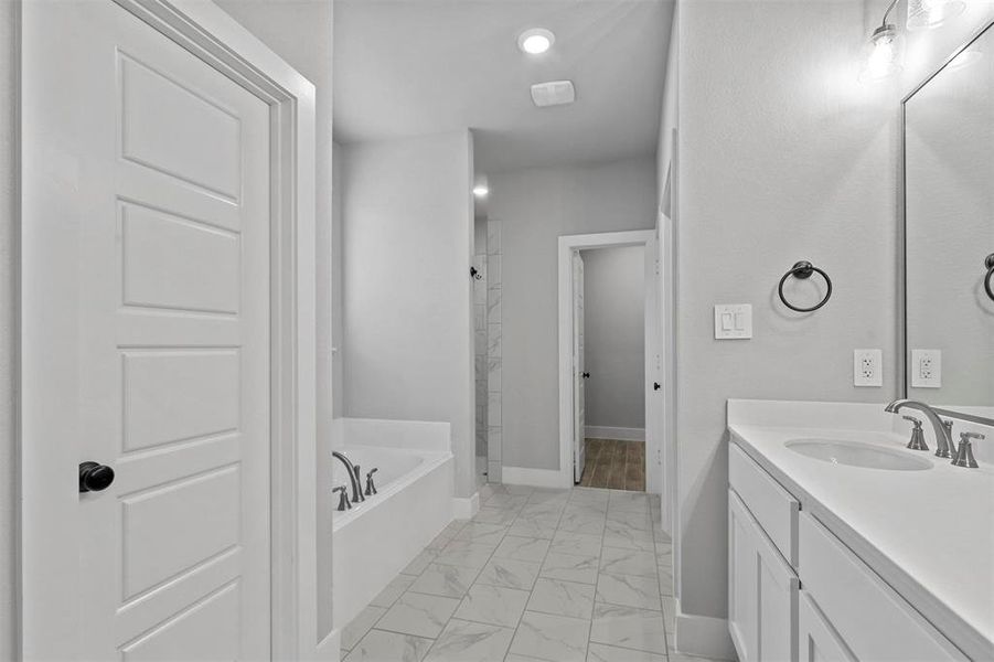 Bathroom with vanity and separate shower and tub