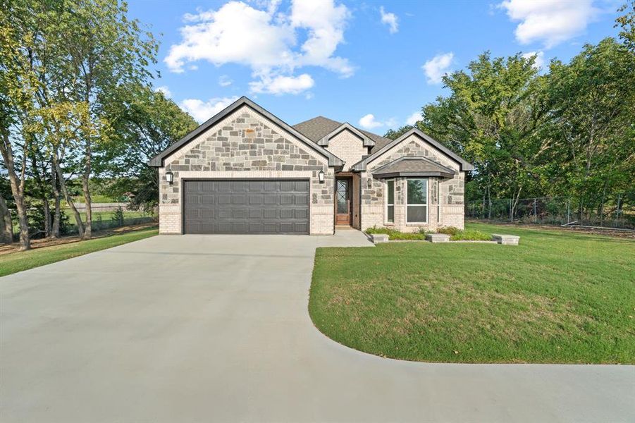 Front exterior of a new home in , Gainesville, TX, highlighting curb appeal (Image 21). Front exterior of a new home in , Gainesville, TX, highlighting curb appeal (Image 21).