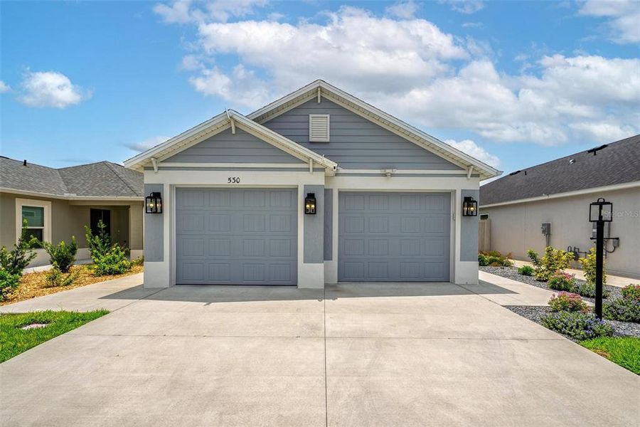 Front exterior of a new home in , The Villages, FL, highlighting curb appeal (Image 19).
