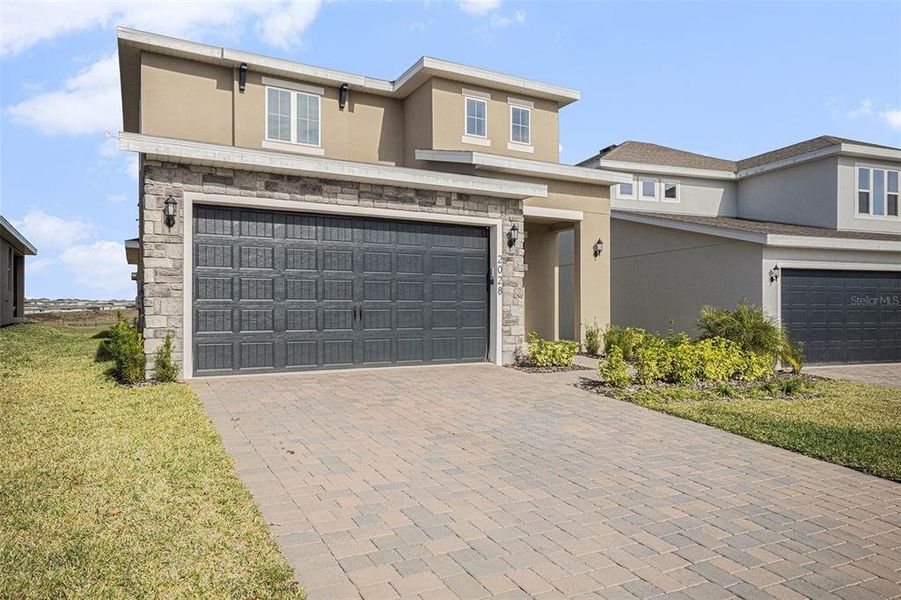 Front exterior of a new home in Hills of Minneola, Minneola, FL, highlighting curb appeal (Image 16).