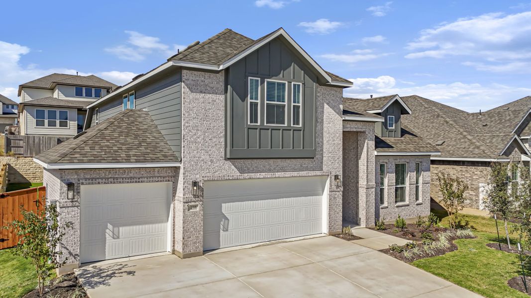 Front exterior of a new home in Santa Rita Ranch, Liberty Hill, TX, highlighting curb appeal (Image 28).