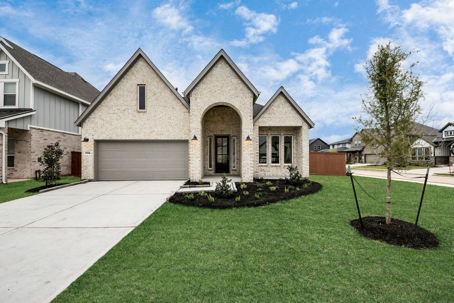 Front exterior of a new home in 50' Traditional Homes at Elyson, Katy, TX, highlighting curb appeal (Image 20). Front exterior of a new home in 50' Traditional Homes at Elyson, Katy, TX, highlighting curb appeal (Image 20).