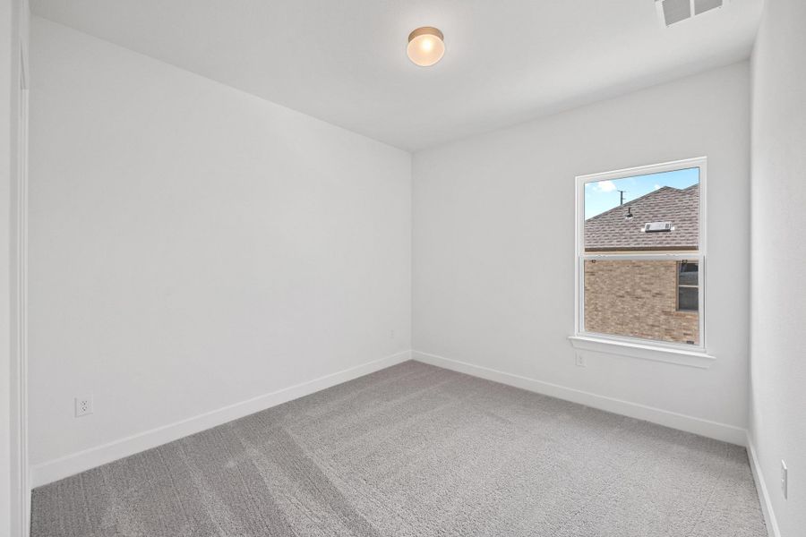 Carpeted empty room with baseboards Carpeted empty room with baseboards