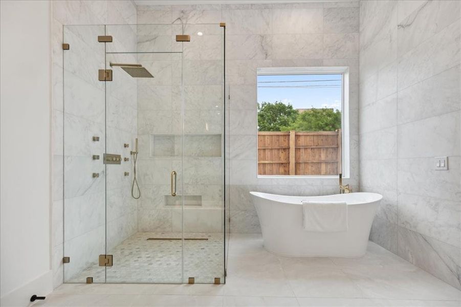 Bathroom with tile walls, separate shower and tub, and tile floors