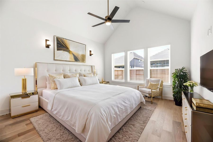 The spacious Primary Suite offers a tranquil retreat, featuring soaring vaulted ceilings and abundant natural light to create a peaceful atmosphere for relaxation. Virtually staged.