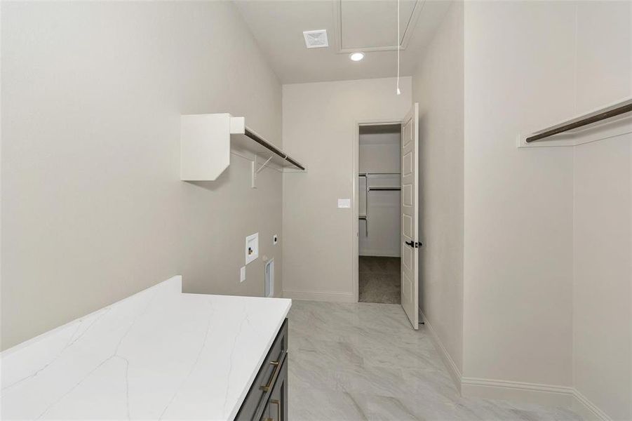 Washroom with washer hookup, hookup for an electric dryer, cabinet space, attic access, and recessed lighting