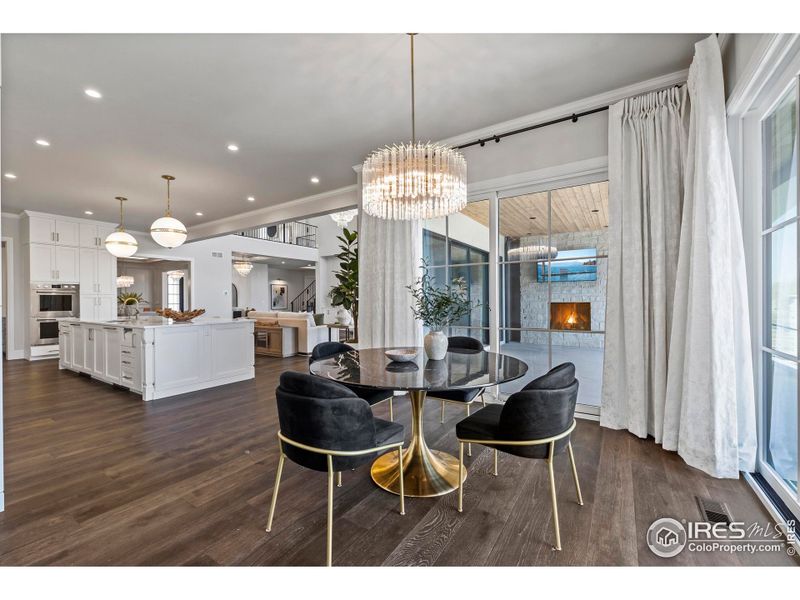 Bright breakfast nook opening to outdoor dining and pool area