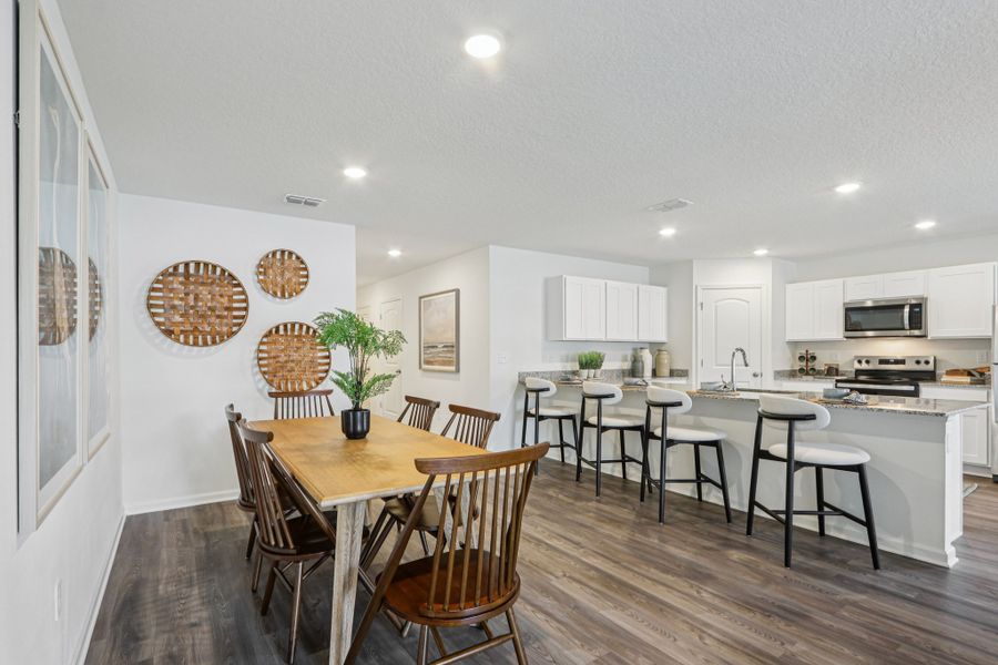 A kitchen with a dining table and chairs. A kitchen with a dining table and chairs.