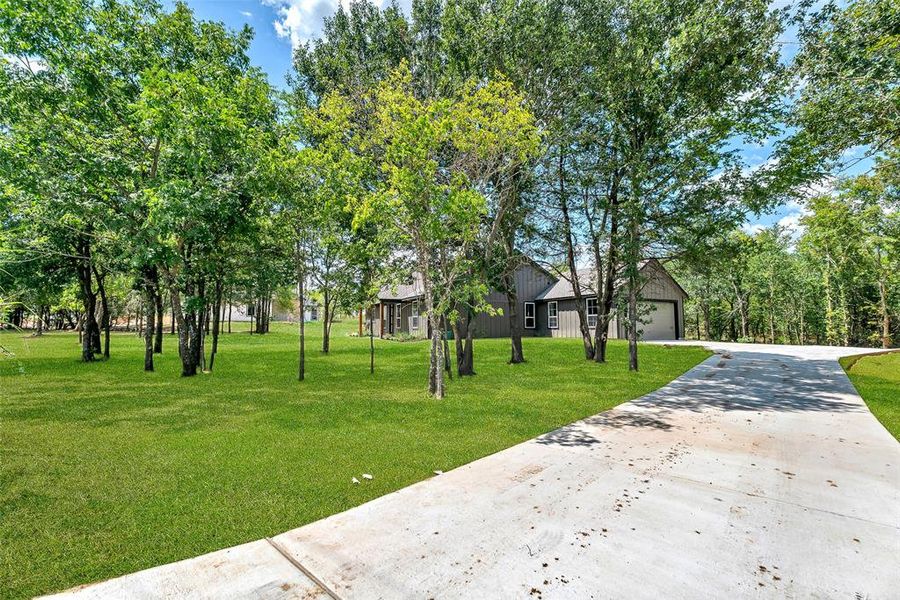 Front exterior of a new home in , Ennis, TX, highlighting curb appeal (Image 21). Front exterior of a new home in , Ennis, TX, highlighting curb appeal (Image 21).