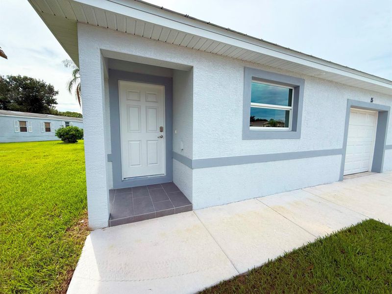 Front exterior of a new home in , Port St. Lucie, FL, highlighting curb appeal (Image 19). Front exterior of a new home in , Port St. Lucie, FL, highlighting curb appeal (Image 19).