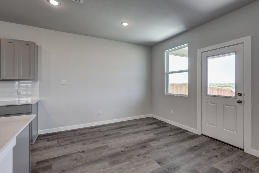 A room with a wood floor and a white door. A room with a wood floor and a white door.