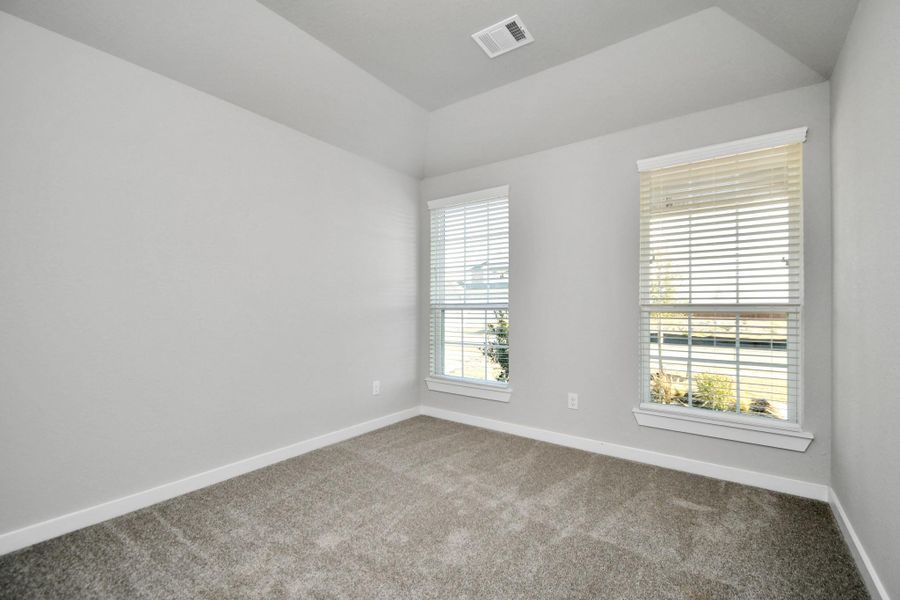 Inviting guest suite adorned with modern charm. The room features elegant 5-panel doors with sleek, contemporary hardware that adds a touch of sophistication. Sink your feet into the plush, fluffy carpet that invites comfort and warmth. Large windows flood the space with an abundance of natural light, framed by privacy blinds that offer the perfect balance between openness and seclusion. Sample photo of completed home with similar floor plan. As-built interior colors and selections may vary. Inviting guest suite adorned with modern charm. The room features elegant 5-panel doors with sleek, contemporary hardware that adds a touch of sophistication. Sink your feet into the plush, fluffy carpet that invites comfort and warmth. Large windows flood the space with an abundance of natural light, framed by privacy blinds that offer the perfect balance between openness and seclusion. Sample photo of completed home with similar floor plan. As-built interior colors and selections may vary.