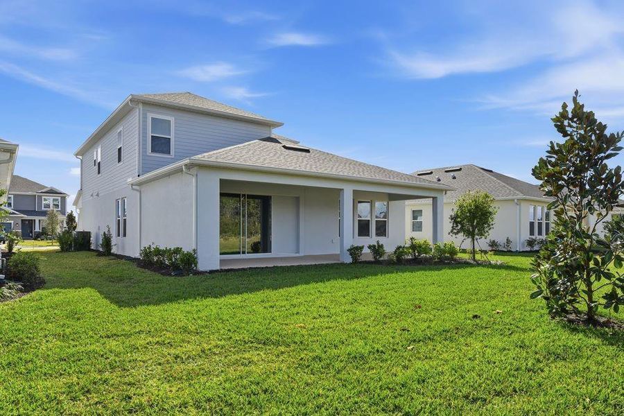 Exterior details and patio area of a home in Ardisia Park, New Smyrna Beach (Image 4).