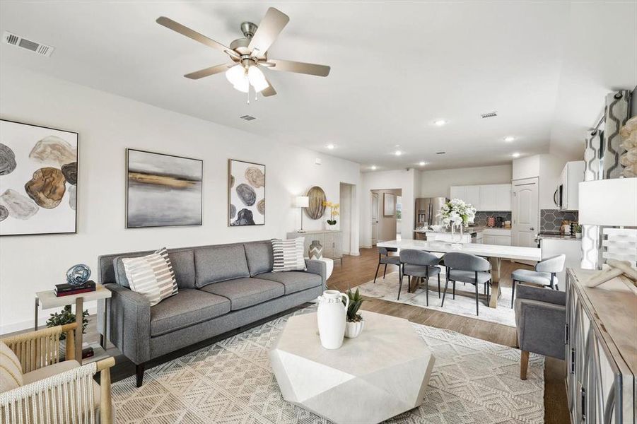 Living area with light wood-style floors, recessed lighting, and ceiling fan
