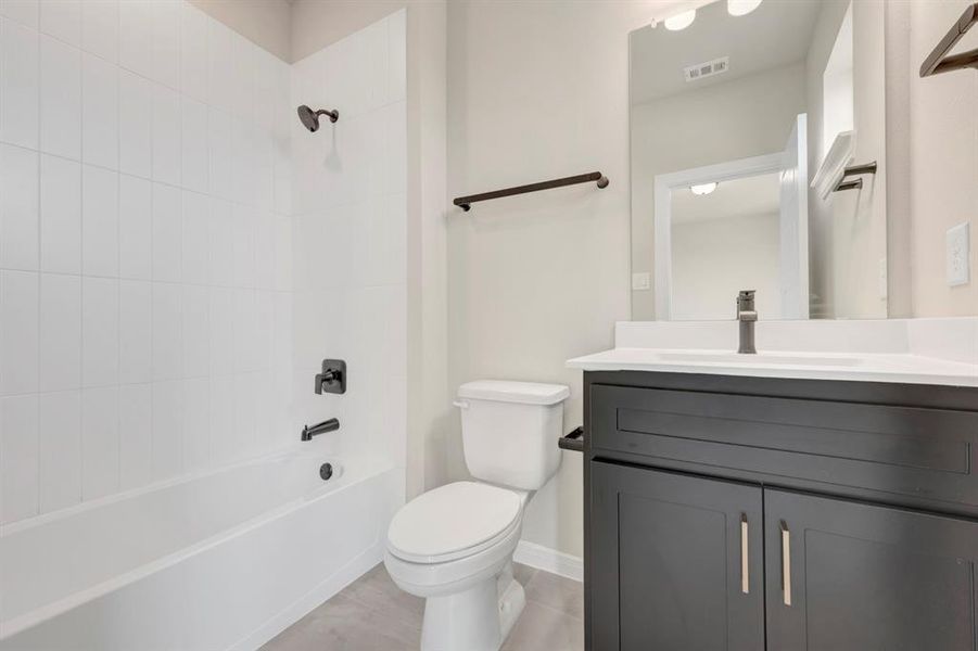 Bathroom featuring shower / washtub combination and vanity