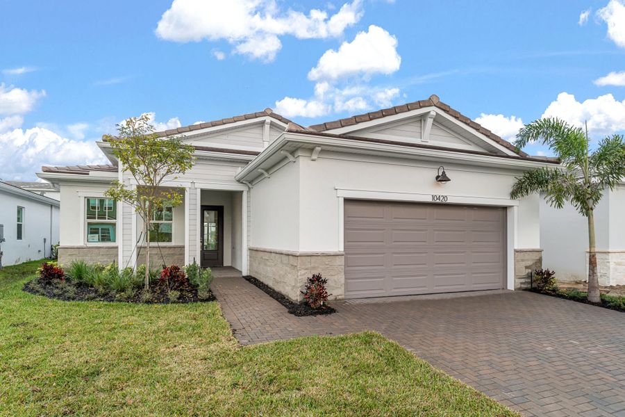 Front exterior of a new home in Tradition, Port St. Lucie, FL, highlighting curb appeal (Image 1). Front exterior of a new home in Tradition, Port St. Lucie, FL, highlighting curb appeal (Image 1).