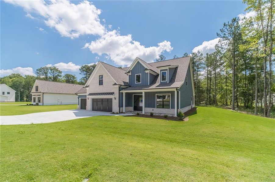 Front exterior of a new home in , Loganville, GA, highlighting curb appeal (Image 27).