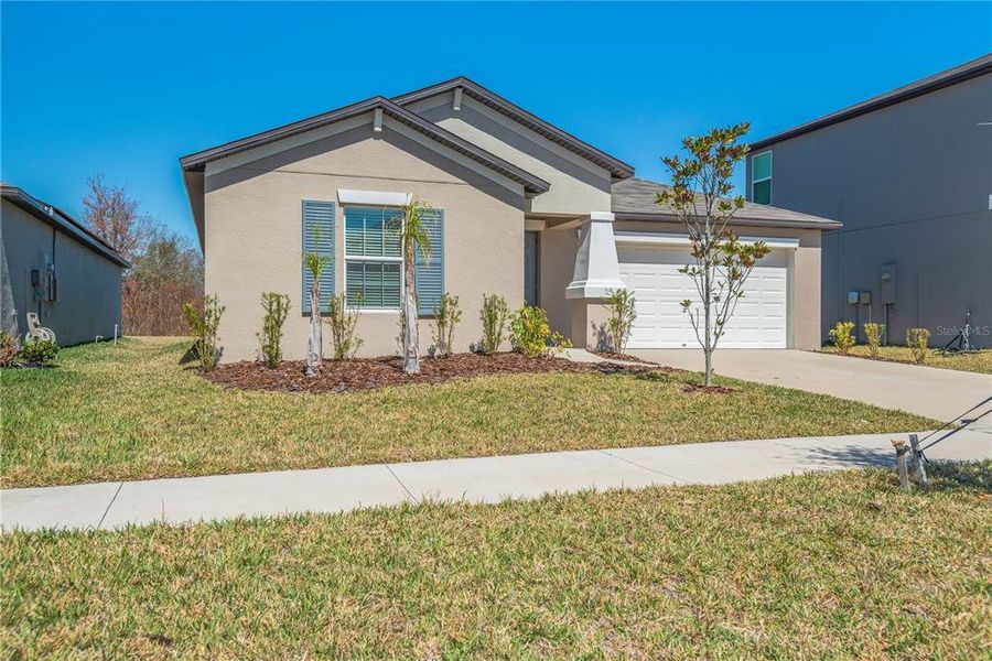 Front exterior of a new home in Berry Bay, Wimauma, FL, highlighting curb appeal (Image 2). Front exterior of a new home in Berry Bay, Wimauma, FL, highlighting curb appeal (Image 2).