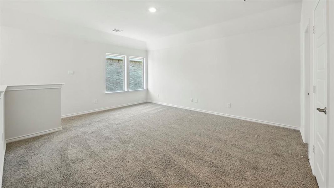 Empty room with light colored carpet and recessed lighting Empty room with light colored carpet and recessed lighting