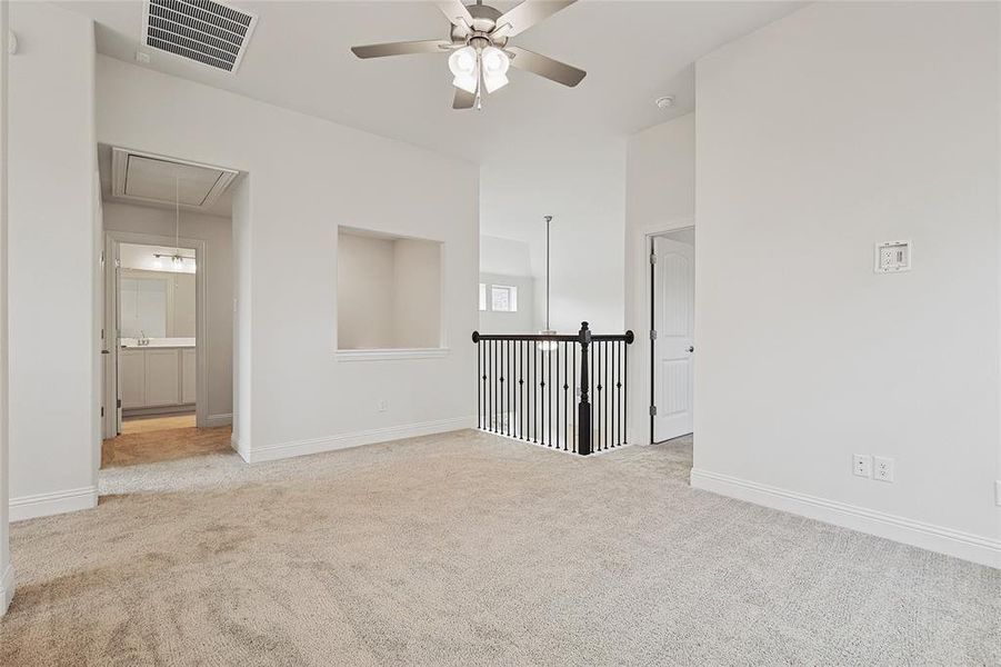 Carpeted spare room with ceiling fan