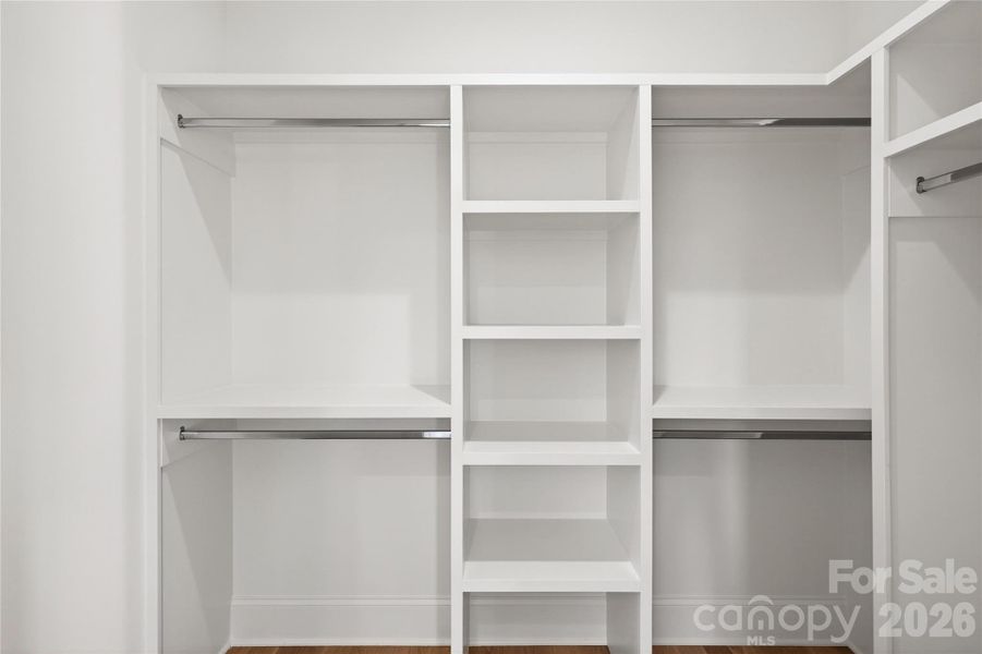 2nd Bedroom Closet, Upper Level, walk-in with shelving for sweaters, closet rods for shirt, skirts, jeans, dresses on the right-hand side and coats.