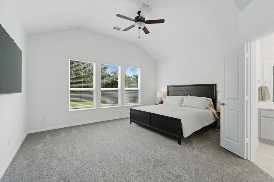 A naturally illuminated bedroom offers high ceilings and soft carpeting, creating a tranquil retreat. A naturally illuminated bedroom offers high ceilings and soft carpeting, creating a tranquil retreat.