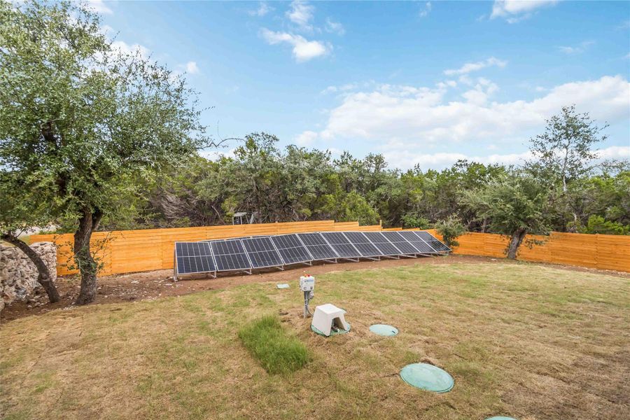 View of solar panels and back fence
