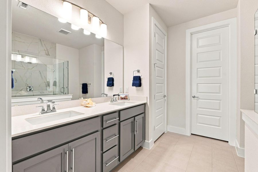Primary en-suite bath with dual vanity, Blanco Maple counters, rectangular undermount sinks, and North Sea painted cabinetry. Primary en-suite bath with dual vanity, Blanco Maple counters, rectangular undermount sinks, and North Sea painted cabinetry.