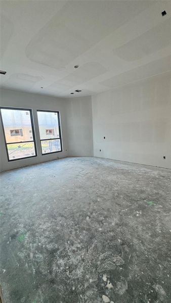 Primary bedroom with sitting area.