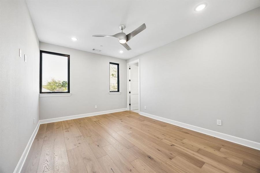 Spare room featuring a ceiling fan, light wood finished floors, and recessed lighting Spare room featuring a ceiling fan, light wood finished floors, and recessed lighting
