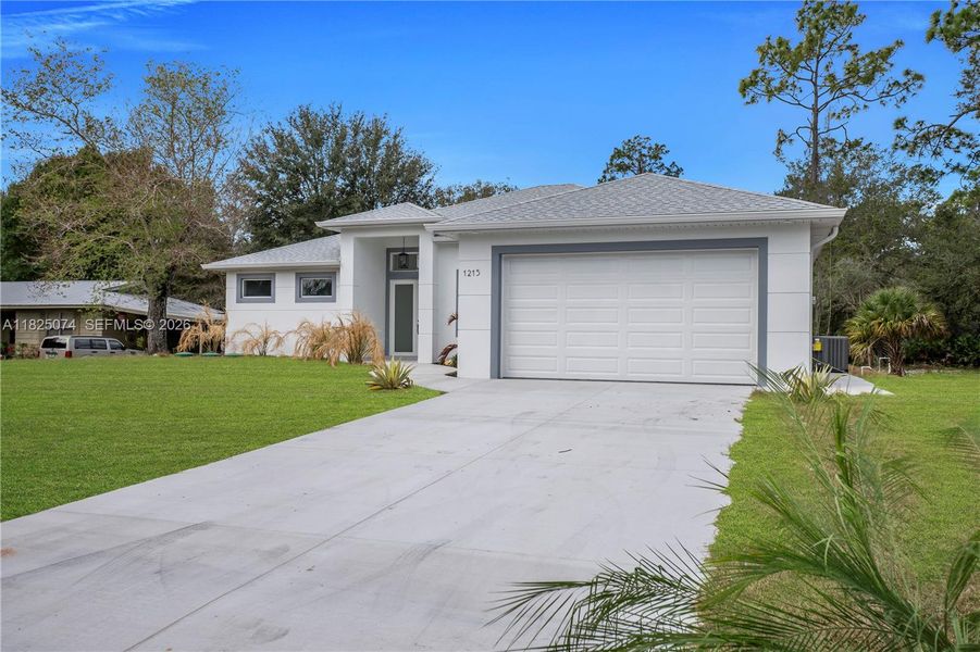 Front exterior of a new home in , Lehigh Acres, FL, highlighting curb appeal (Image 26).