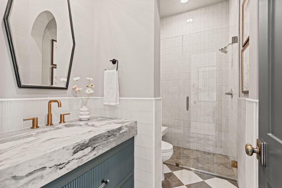 First floor powder room features shower with bench First floor powder room features shower with bench