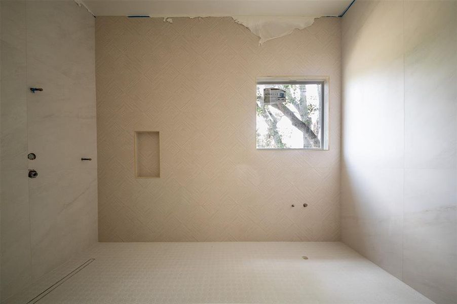 This textured tile on the back wall needs be felt to truly appreciate the elegance and detail of this walk in shower and tub combo.