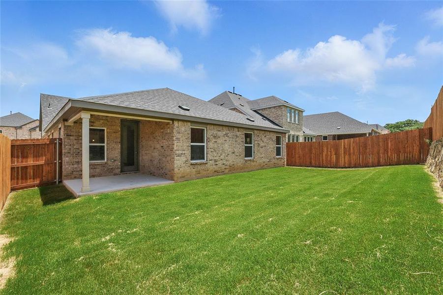Back of house featuring brick siding, a patio, and a fenced backyard Back of house featuring brick siding, a patio, and a fenced backyard