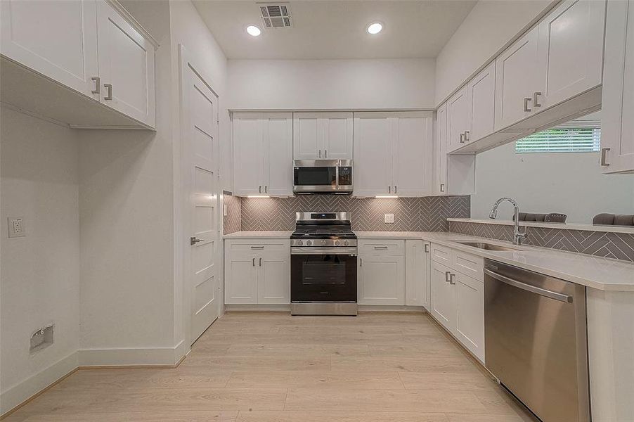 Appliances include Samsung stainless steel dishwasher, Samsung stainless steel microwave and Samsung stainless steel oven with 4 burners and griddle. 11x9 kitchen also has stainless single basin undermount sink and American Standard polished nickel goose neck faucet with sprayer.