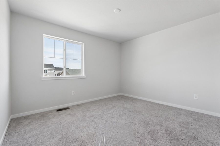 A room with a window and a carpet. A room with a window and a carpet.