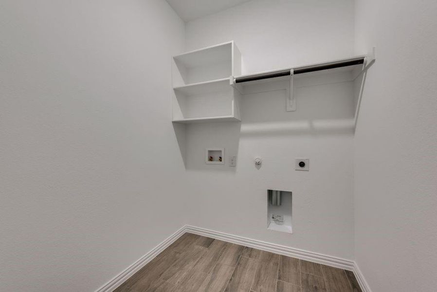 Laundry room with hookup for a washing machine, hookup for an electric dryer, hardwood / wood-style floors, and hookup for a gas dryer