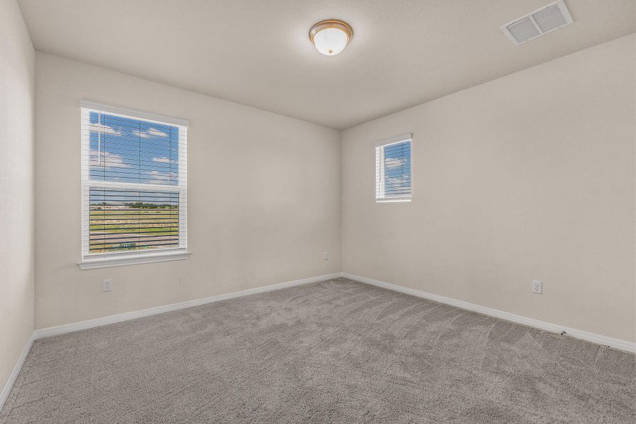 Carpeted empty room featuring baseboards Carpeted empty room featuring baseboards