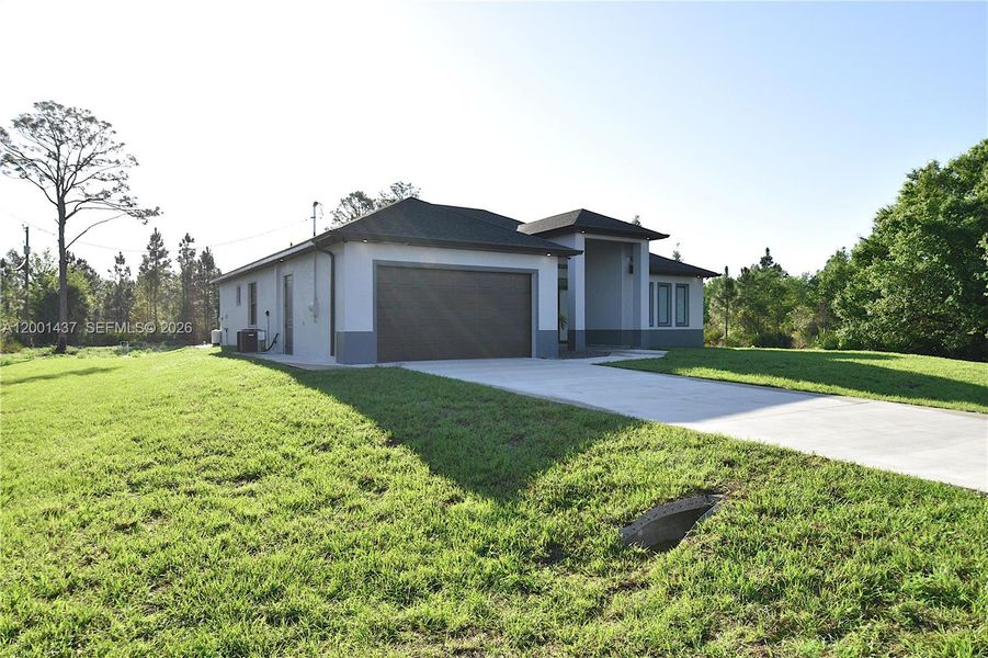 Front exterior of a new home in , Lehigh Acres, FL, highlighting curb appeal (Image 20).