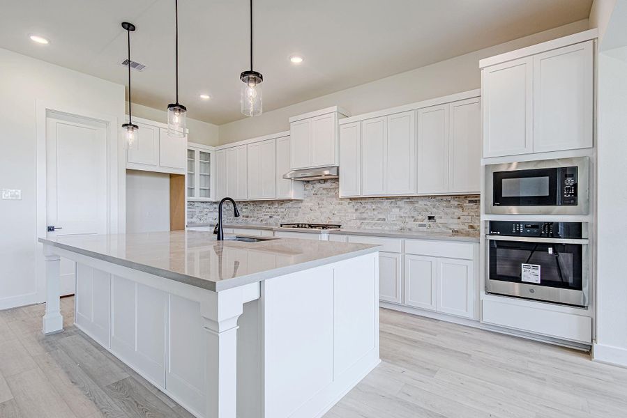 Built-in stainless steel appliances and ample counter space highlight this modern kitchen