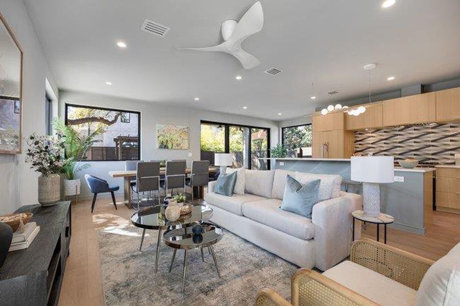 The living room, dining room and kitchen flow seamlessly to create space to gather. 9 ft ceilings throughout.