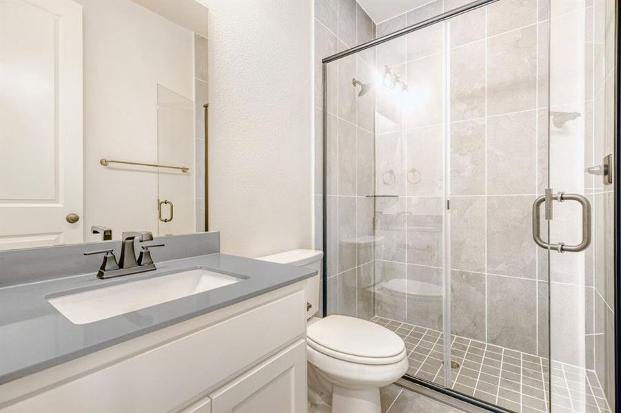 Bathroom featuring a white vanity with a light gray countertop, undermount sink, and polished chrome faucet
