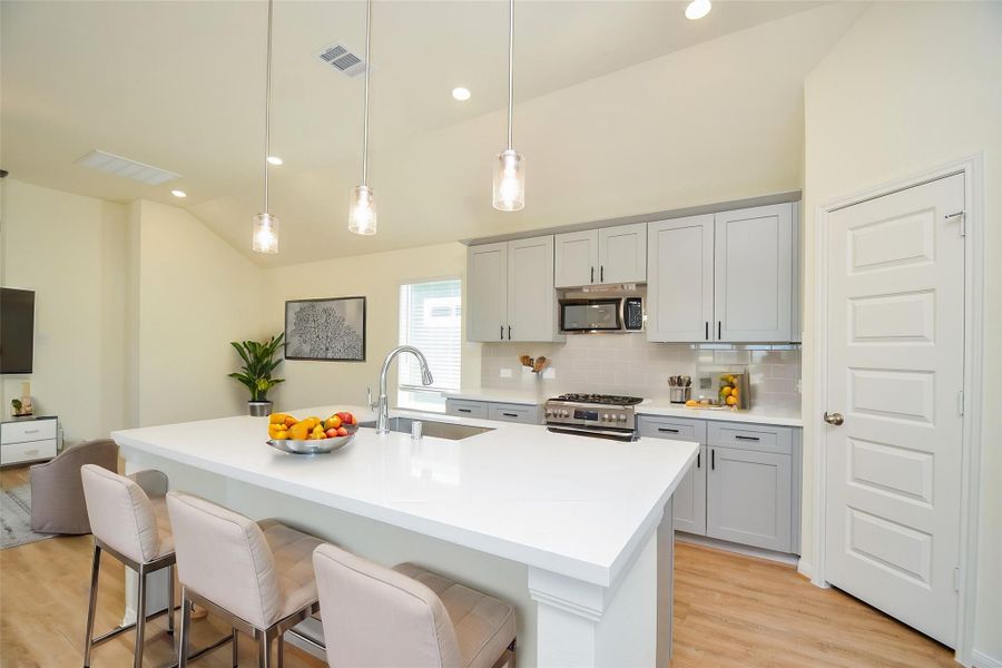 The spacious island provides a central focal point, perfect for entertaining and meal preparation.