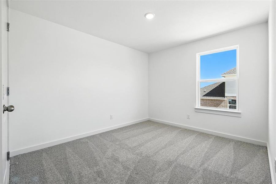 Unfurnished room featuring carpet flooring and baseboards Unfurnished room featuring carpet flooring and baseboards