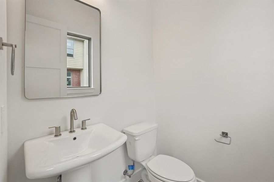 Half bath featuring a sink and toilet