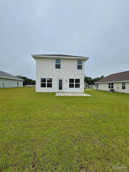 Front exterior of a new home in Pine Top, Cantonment, FL, highlighting curb appeal (Image 2).