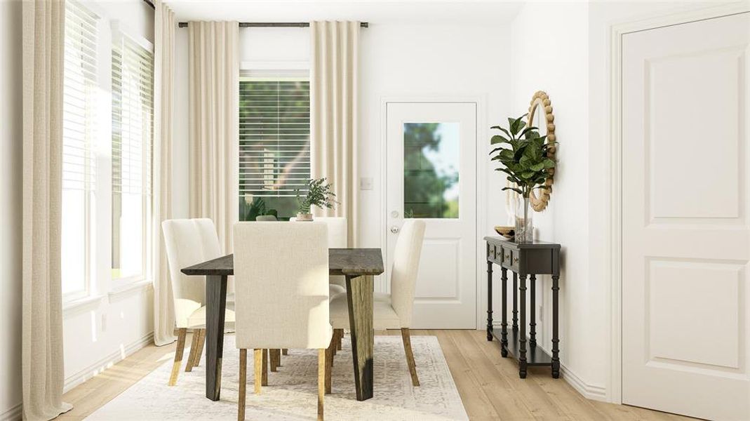 Dining space with a healthy amount of sunlight and light hardwood / wood-style flooring