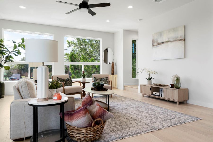 Living room featuring recessed lighting, a ceiling fan, and light wood finished floors