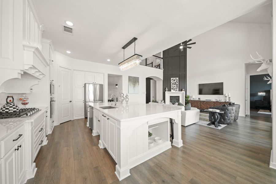 With gleaming waterproof Revwood floors, this layout keeps the kitchen and living area visually connected, making it easy to cook, relax and stay involved in the conversations. Plenty of natural light keeps the space feeling open, bright and comfortable and the storage area to the right of the island is a purrfect place for hiding pet bowls or displaying cookbooks.