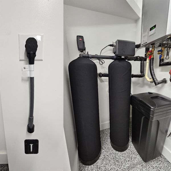 Modern amenities include an electric car charger and an efficient water system with a softener and tankless heaters for convenience and sustainability.